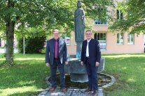 Zwei Männer stehen vor dem „Ludwigsbrunnen“ am Amt für Ländliche Entwicklung Niederbayern in Landau a.d.Isar